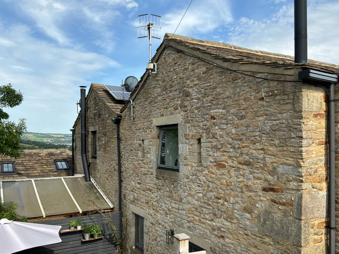 Side elevation of a stone-faced reverse-level home surveyed by Vertex in Keighley
