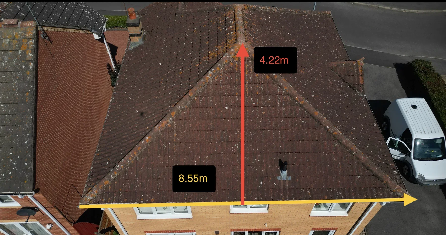 Annotated overhead photograph of a hipped roof with ridge-to-eaves and eaves measurements